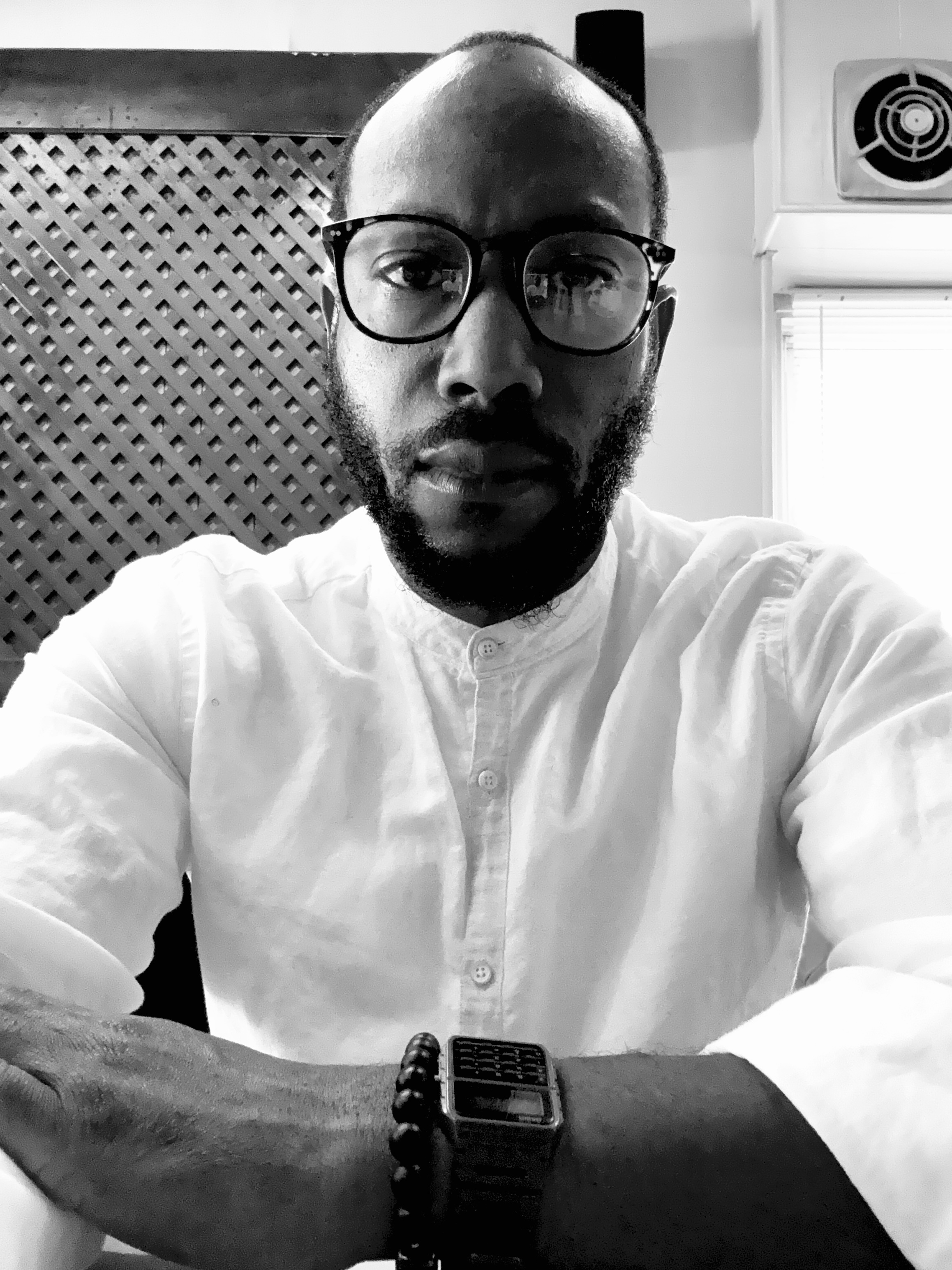 Lawrence Cox wearing glasses and a white shirt
